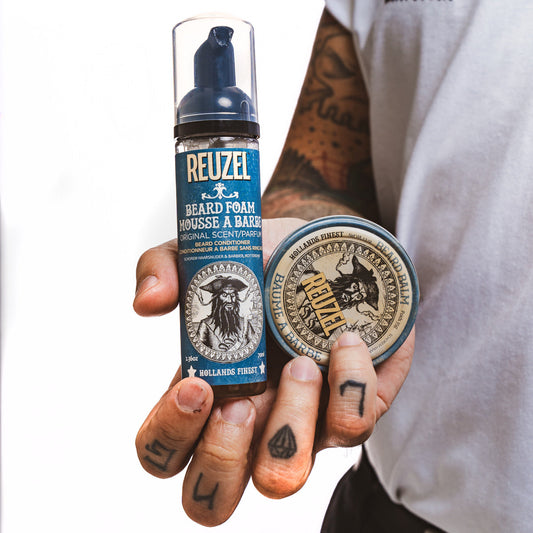 Reuzel beard foam in a bottle, showcasing its creamy texture and packaging for beard grooming and styling.