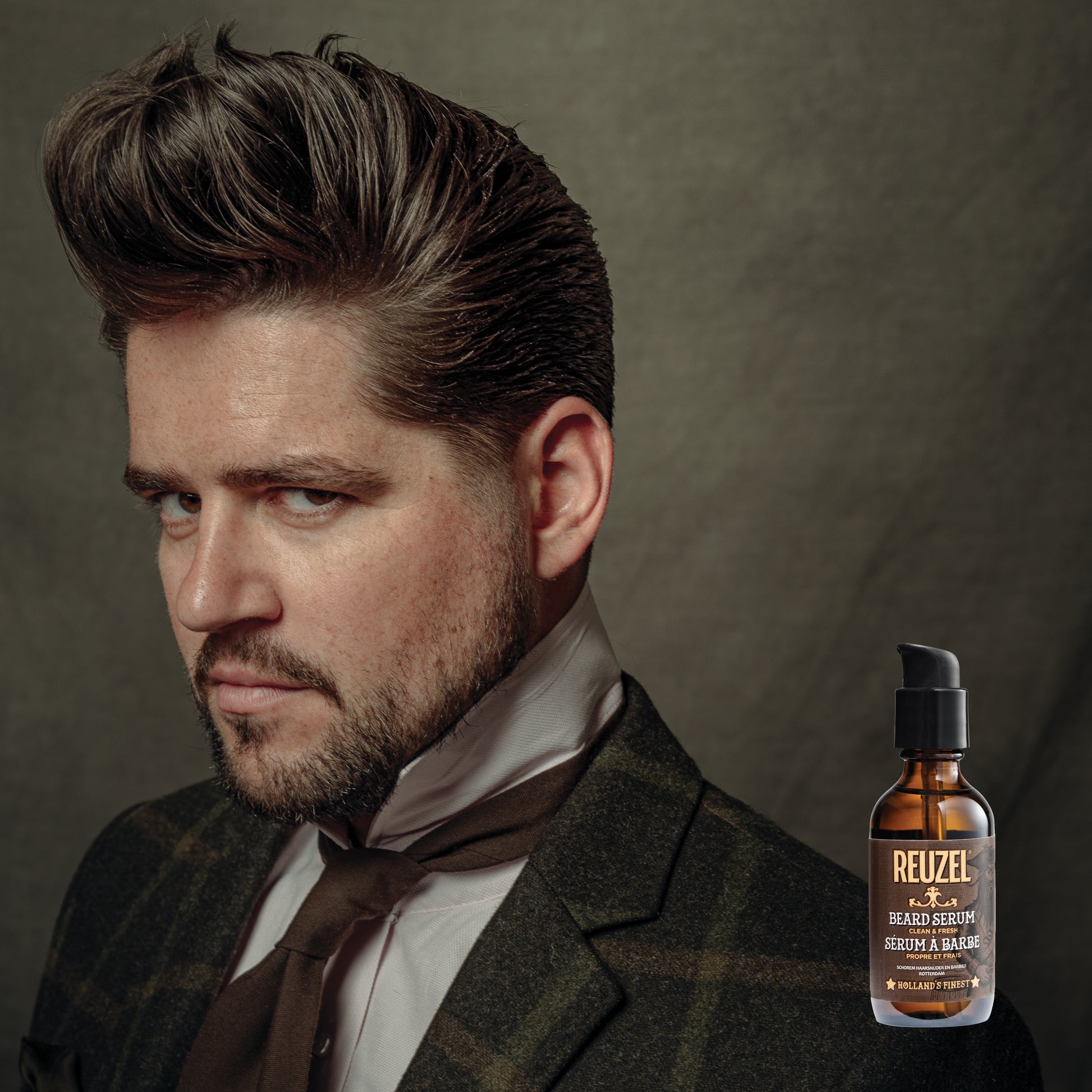 Reuzel beard oil in a clear bottle showing the clean and fresh beard serum, designed to nourish and soften facial hair.