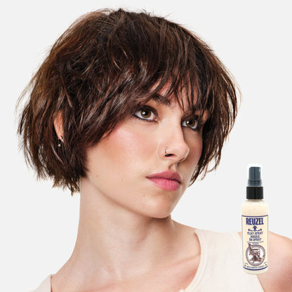 Reuzel clay spray hair styling product in a spray bottle, designed for textured, matte finish hairstyles.