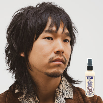 Reuzel Clay Spray for hair styling, showing the spray bottle with label and product details on a clean background.