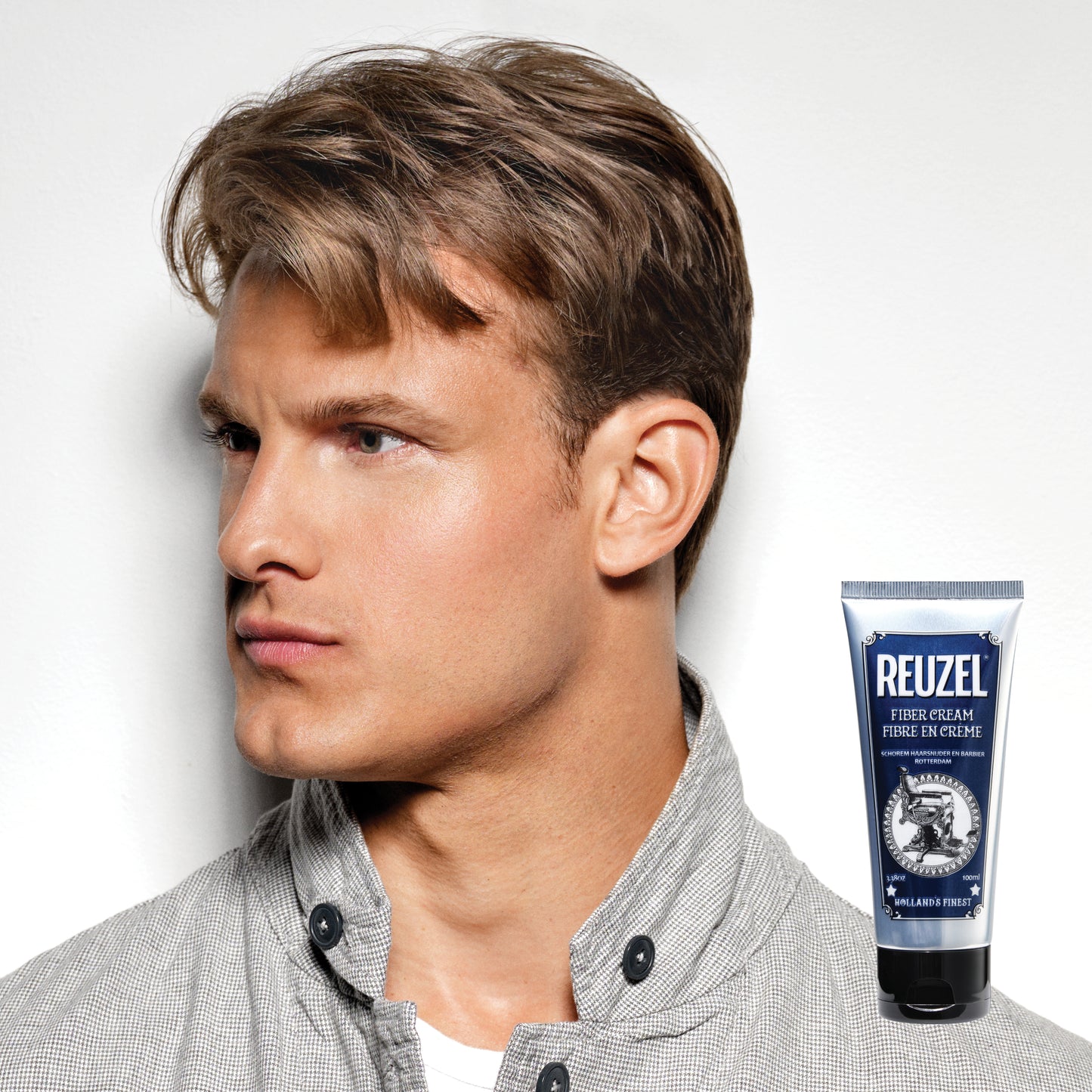 Reuzel Fiber Cream hair styling product in a jar, showing the textured cream with a smooth finish and branding on the container.