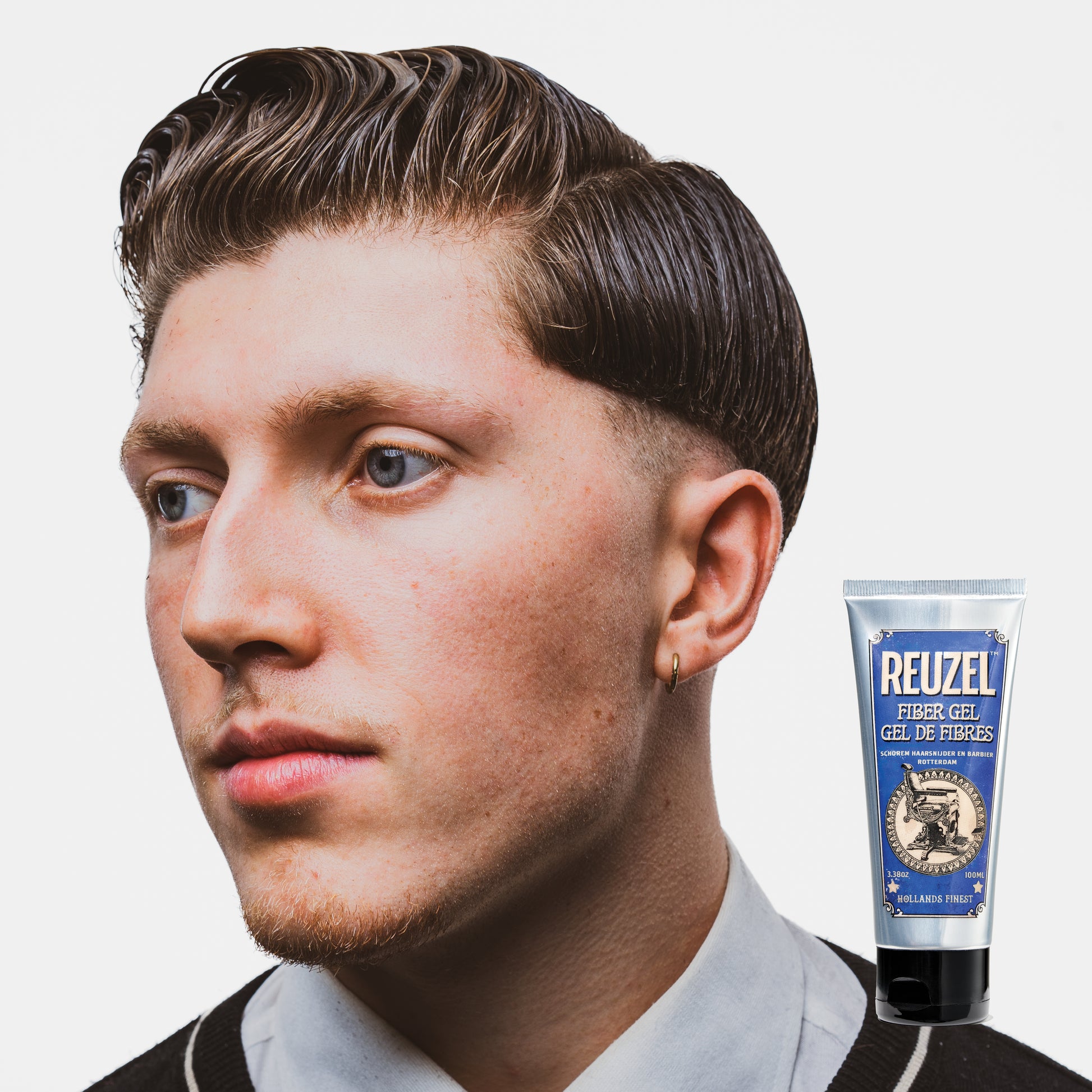 Reuzel Fiber Gel hair styling product showing a close-up of the gel texture in a container, ideal for thick, strong hold styling.