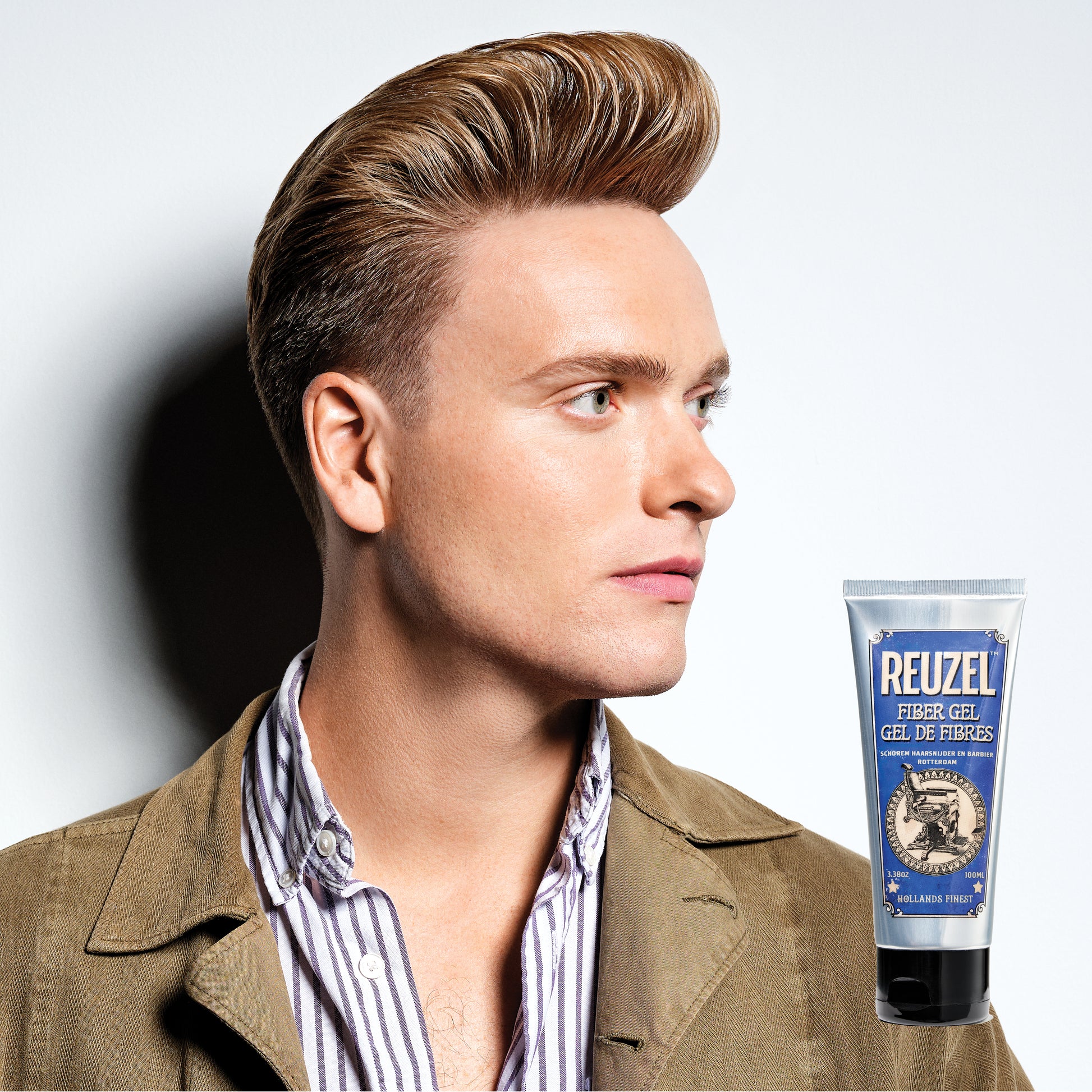 Reuzel Fiber Gel hair styling product with thickening and hold properties, shown in a clear container with a blue label.