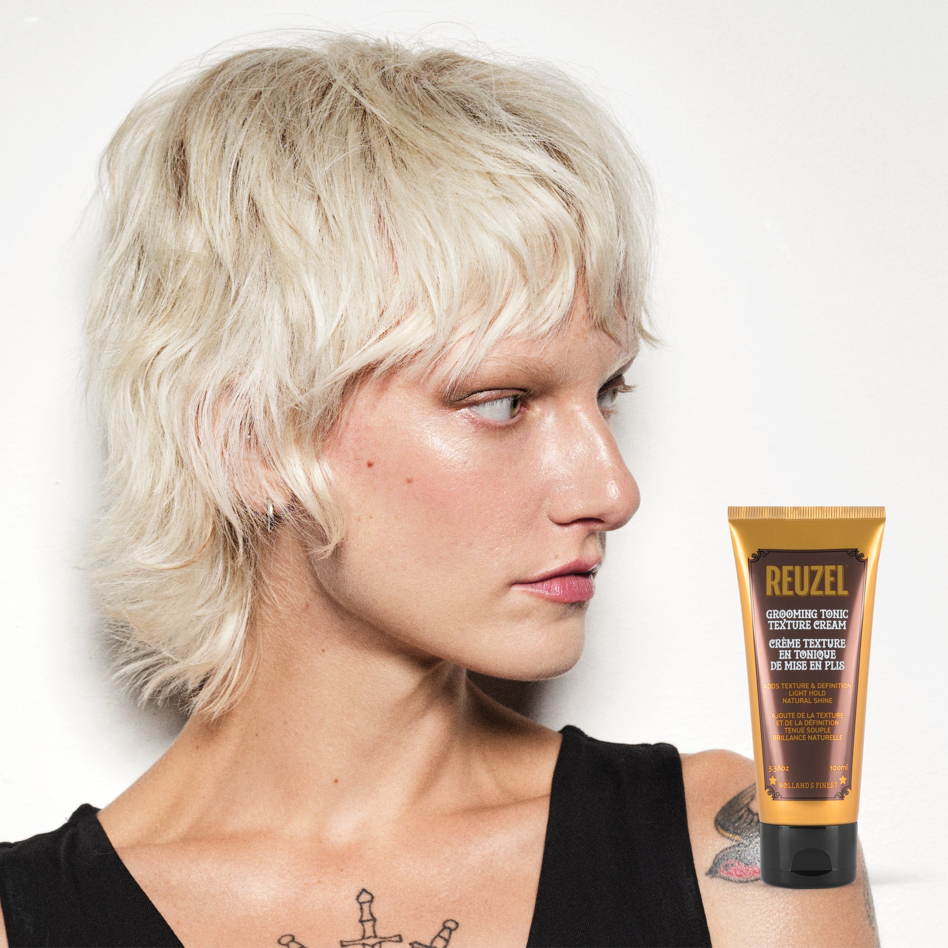 Reuzel Grooming Tonic Texture Cream in a jar, showcasing the hair styling product with a textured cream appearance.