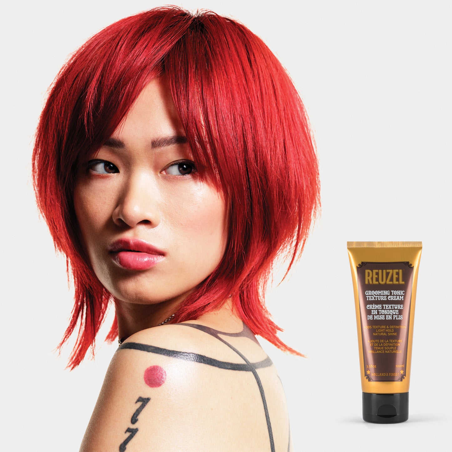 Reuzel Grooming Tonic Texture Cream for hair styling, showing a jar of styling cream with a textured finish and label.