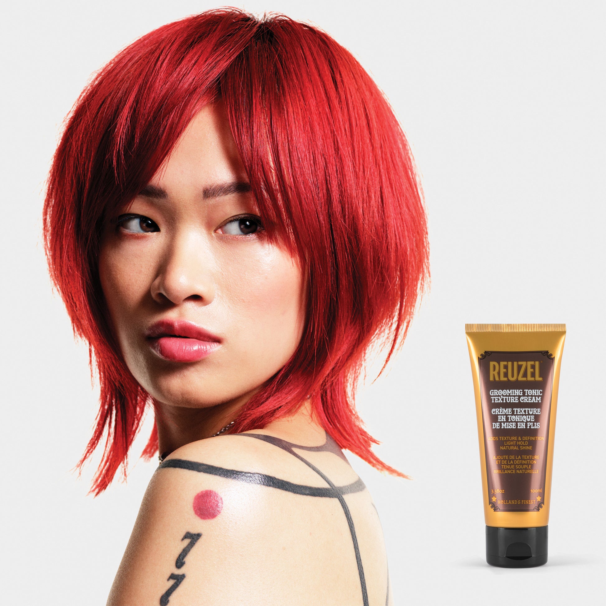 Reuzel Grooming Tonic Texture Cream for hair styling, showing a jar of styling cream with a textured finish and label.