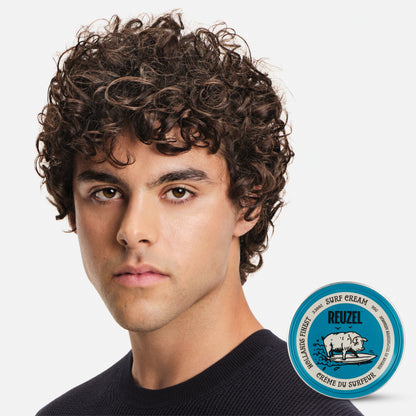 Reuzel Surf Cream pomade in a jar, showcasing the product's creamy texture and branding for textured, beachy hairstyle.