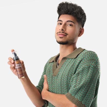 Reuzel Grooming Tonic Texture Foam for hair styling, showing the foamy product in a white bottle on a neutral background.