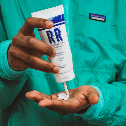 Reuzel hydrating face moisturizer in a sleek jar, showing the creamy texture and skincare branding on the label.